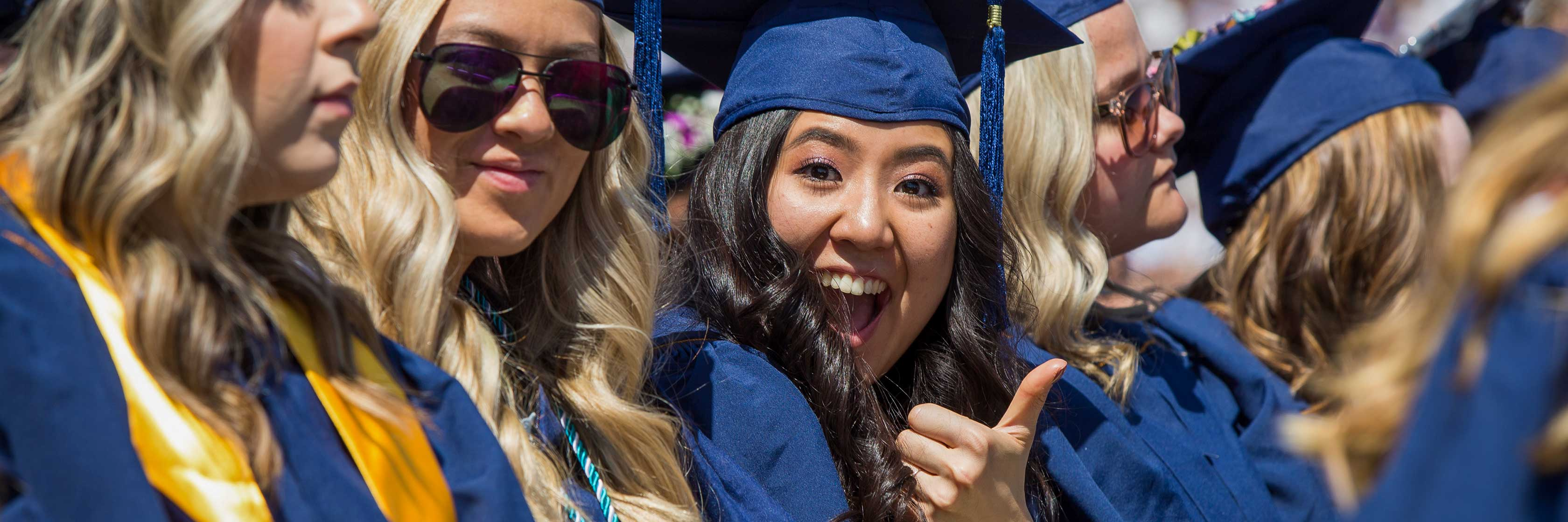 UNC Students gives a thumbs up while waiting for her name to be called.